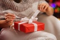 Closeup on woman opening Christmas present box