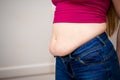 Closeup of woman pinching belly fat. Royalty Free Stock Photo