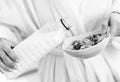 Closeup on woman pouring milk into plate with oatmeal Royalty Free Stock Photo