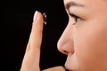 Closeup of woman putting contact lenses