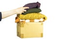 Closeup woman putting shirt in carton box with used clothes for donation, collection and support of war victims, helping people, c Royalty Free Stock Photo