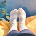 Closeup woman relaxes on sofa in white striped socks