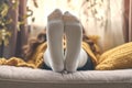 Closeup woman relaxes on sofa in white striped socks