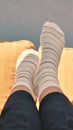 Closeup woman relaxes on sofa in white striped socks