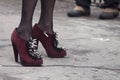 A closeup of a woman`s designer heels on the street Royalty Free Stock Photo