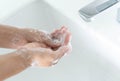 Closeup woman`s hand washing with soap in bathroom, selective focus Royalty Free Stock Photo