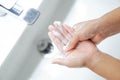 Closeup woman`s hand washing with soap in bathroom, selective focus Royalty Free Stock Photo