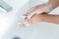 Closeup woman`s hand washing with soap in bathroom, selective focus Royalty Free Stock Photo