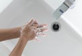 Closeup woman`s hand washing with soap in bathroom, selective focus Royalty Free Stock Photo