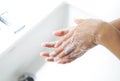 Closeup woman`s hand washing with soap in bathroom, selective focus Royalty Free Stock Photo