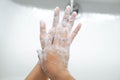 Closeup woman`s hand washing with soap in bathroom, selective focus Royalty Free Stock Photo
