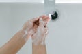 Closeup woman`s hand washing with soap in bathroom, selective focus Royalty Free Stock Photo