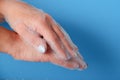 Closeup woman's hand washing with soap on a blue background , selective focus. Practice good Royalty Free Stock Photo