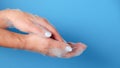 Closeup woman's hand washing with soap on a blue background , selective focus. Practice good Royalty Free Stock Photo