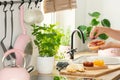 Closeup of woman`s hands above a wooden countertop with a cuttin