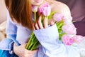 Closeup of woman`s hands holding bouquet of pink tulips. Royalty Free Stock Photo