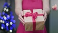 Woman`s Hands Holding a Christmas Gift