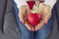 Closeup of woman`s hands holding red heart as symbol of sharing love and giving Valentine gifts Royalty Free Stock Photo