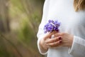 Closeup of woman`s hands with small bunch of beautiful blue snowdrops. Spring mood. Girl with flowers Royalty Free Stock Photo