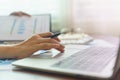 Closeup woman`s hands typing on a laptop on a wooden desk.Working at home with laptop Royalty Free Stock Photo