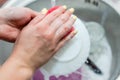 Close up woman`s hands of washing dishes in kitchen sink. Cleaning chores Royalty Free Stock Photo