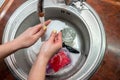 Close up woman`s hands of washing dishes in kitchen sink. Cleaning chores Royalty Free Stock Photo