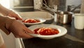 Closeup of woman serving dinner and taking two bowls with hot soup. Domestic food, cooking at home, housewife working Royalty Free Stock Photo