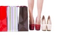 Closeup of woman shopper legs, high heels and shopping bags