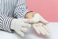 Closeup woman showing disinfected clean hand skin under protective sterile gloves. Hygiene concept Royalty Free Stock Photo