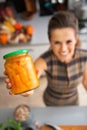 Closeup on woman showing jar of pickled pumpkin Royalty Free Stock Photo