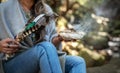 Woman holding a smudging wand and incense in a forest Royalty Free Stock Photo