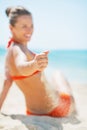 Closeup on woman sitting on beach and playing with sand Royalty Free Stock Photo