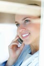 Closeup of a woman speaking on cellphone , view through glass. Closeup of a happy female having a conversation over the