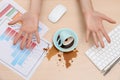 Closeup of woman spilled coffee on office desk, top view Royalty Free Stock Photo