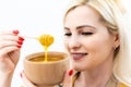 closeup of woman and spoon with honey on white background