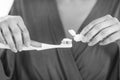 Closeup on young woman squeezing toothpaste on toothbrush Royalty Free Stock Photo