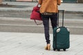 woman standing in the street with suitcase and back Royalty Free Stock Photo