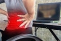 Woman suffering from office syndrome having lower back pain sitting on chair Royalty Free Stock Photo