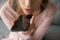 Closeup woman talk on speakerphone through microphone built into device