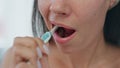 Closeup woman toothbrushing process at bath. Lady brushing teeth cleaning mouth