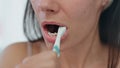 Closeup woman toothbrushing process at bath. Lady brushing teeth cleaning mouth