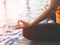 Closeup woman training yoga and meditation at poolside Royalty Free Stock Photo