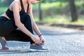 Closeup of woman tying shoe laces. Female sport fitness runner g Royalty Free Stock Photo