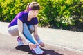 Closeup of woman tying shoe laces. Female sport fitness runner getting ready for jogging outdoors on forest path Royalty Free Stock Photo