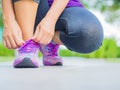 closeup of woman tying shoe laces. Female sport fitness runner getting ready for jogging Royalty Free Stock Photo