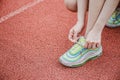 Closeup of woman tying shoe laces. Royalty Free Stock Photo