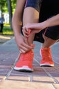 Closeup woman tying shoe laces. Street runner getting ready for training. Royalty Free Stock Photo