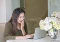 Closeup asian woman use computer notebook in room with happy face emotion under window light in lifestyle of woman concept Royalty Free Stock Photo