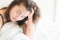 Closeup woman waking up with sore head on bed, health care and m Royalty Free Stock Photo