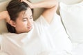 Closeup woman waking up with sore head on bed, health care and m Royalty Free Stock Photo